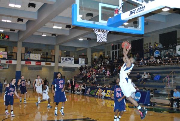 Junior guard Donte Briscoe (in his pink laces) elevates for an alley-oop in Wednesday’s loss to Hiram. Photo by Charlie Magovern/The Campus