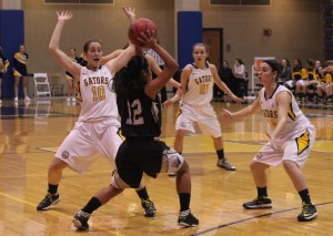 Kendall Hoffman, '15, Rachel Vigliotti, '16 and Marina Scarantino, '15, attempt to block a Wooster player's pass during the Gator's game against Wooster on Wed. Jan. 22, 2013.