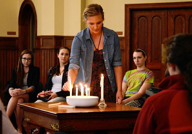 AMASA SMITH/THE CAMPUS
Kelsey Sadlek, ’14, lights a candle as Morgan Mechlenburgh, ’15, Maddy Yemc, ’17, and Alexandrea Rice, ’17, look on during a prayer service in Ford Chapel on April 10, 2014. The service was held by the college for the victims of the Franklin Regional Senior High School stabbing earlier this week. Lead by College Chaplain Jane Ellen Nickell, participants prayed for victims and families affected.
