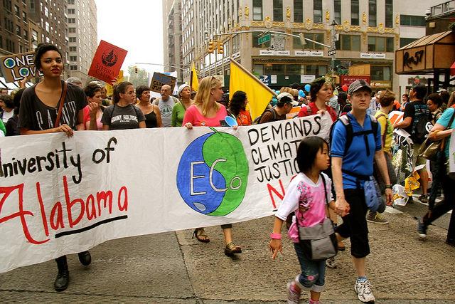Students from University of Alabama march with their signs, demanding climate justice.