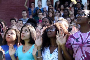 MEGHAN HAYMAN/THE CAMPUS Amanda Warner, ’16, from left, Melanie Perez, ’15, Maya Jones, ’15, and Ifeyinwa Uwazie, ’16, were four of the more than 90 students holding their hands up for the “Hands Up, Don’t Shoot” photo event in front of Bentley Hall on Friday, Aug. 29.