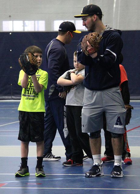 Cy Perry, ‘18, helps Andrew Choffel, age 7, at the Baseball Winter Camp on Feb. 1. 