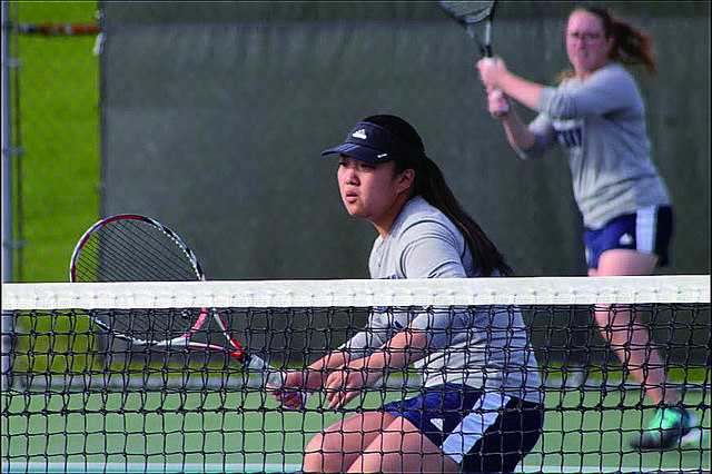 Sun Mo Koo, ‘16, waits for a volley while partner, Sloane Prince ’16, makes a return during the women’s tennis match against Westminster Wednesday evening. The team won 9-0, making it three wins in a row. 