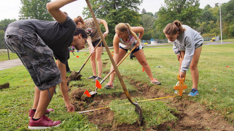  Elia Sherman, ’18, leads a Service Saturday project in creating a shortcut between the Meadville Area High School and the Meadville Area Recreation Complex. The students measure the width of the path while digging and leveling.