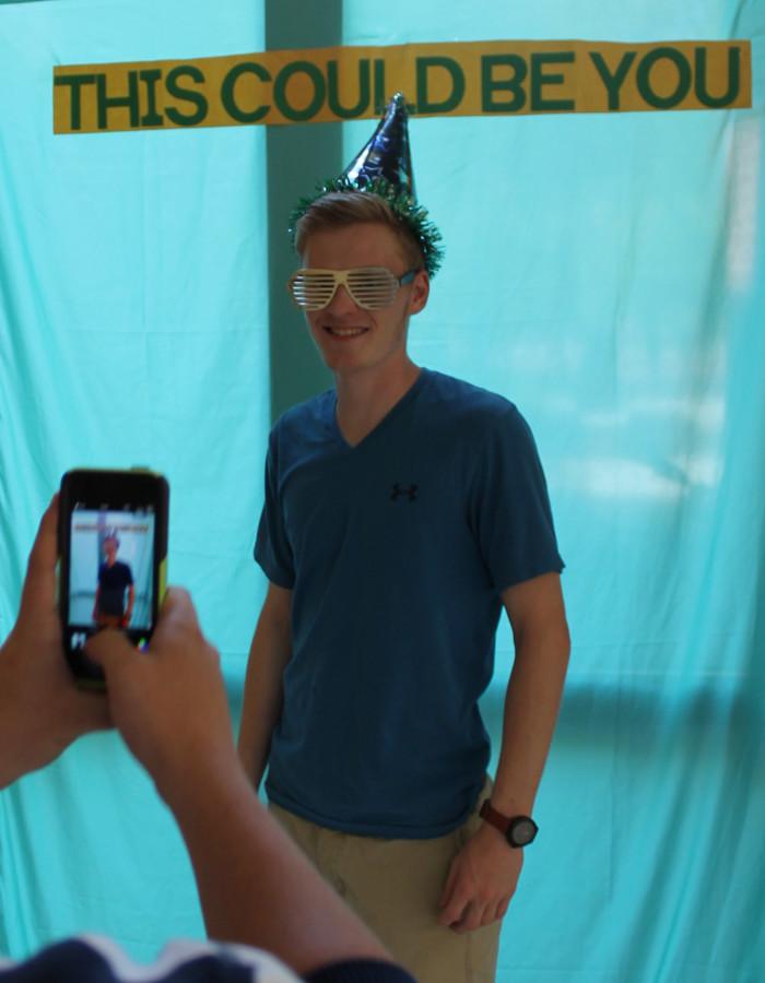 Alex Bakus, ’17, has his photo taken at the promotional photo booth for the Sri Lanka EL Seminar on Wednesday, Sept. 16, 2015. 