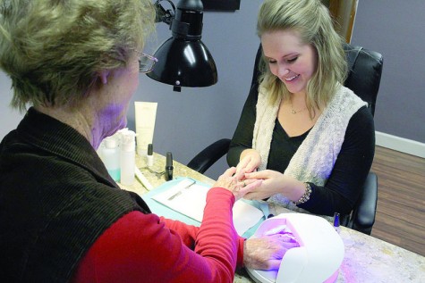 Abby Jones, cosmetologist of five years, massages Jane Yoder’s hands before putting on the first coat of nail polish, on Monday, Nov. 2, 2015. Yoder is a Meadville resident who visits the salon every two weeks to treat herself after doing chores around her home.