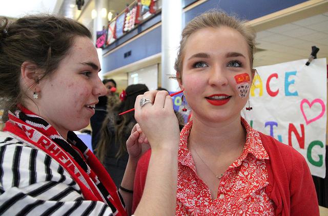 Maggie Dugan, ’18, paints the face of Elsie Hendricks, ’18, during Karneval on Thursday, Feb. 18, 2016. Both students studied abroad in Cologne, Germany last semester and experienced Karneval in the city. 