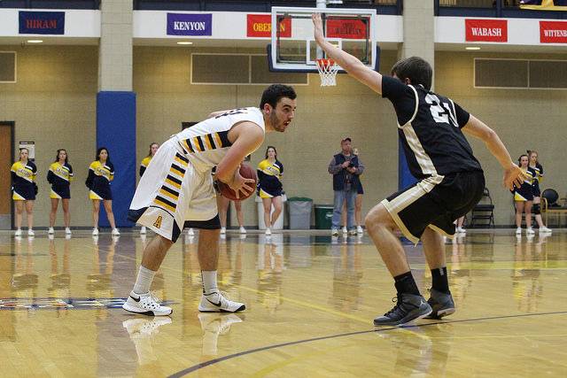 Billy Urso, ’19, looks for a teammate to pass to during the first half of the game aginst the College of Wooster on Wednesday, Feb. 17, 2016. Urso scored a career high of 20 points against the Fighting Scots. 