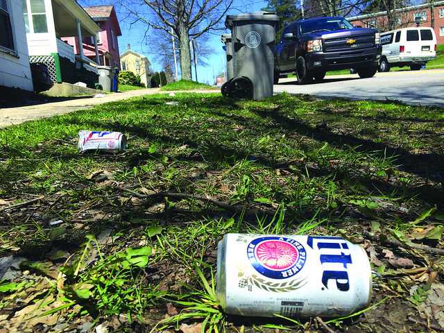 Beer cans litter the side of Park Avenue on Thursday, April 14, 2016, following Springfest activities the weekend prior. 