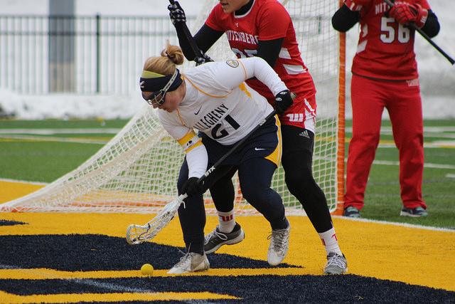 McKenzie Bell, ’16, goes for a ground ball in the game against Wittenberg University on Sunday, April 10, 2016. This season, Bell broke the point record on March 23 and was named NCAC Player of the Week on April 10. 