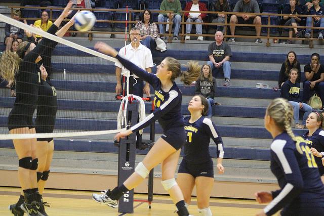 Leah Franzluebbers, ’18, hits the ball over the net   in the game against the College of Wooster. The Gators fell 3-0 to the Scots  in their third NCAC matchup of the  season.