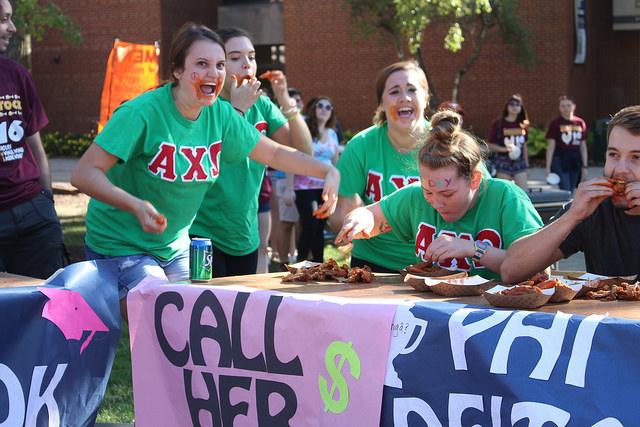 The winning Alpha Chi Omega team, “Call Her Daddy,” constisting of Griffin Sullivan, ’19, Julia Foltz, ’19, Allison Cosgrove, ’18, and Sarah Basden, ’19, compete in the wing eating competition at Wingfest on the Gator Quad on Saturday, Sept. 24, 2016. “Call her Daddy” won the competition and chose to donate the $124 collected from the event to Women’s Services, Inc. in Meadville. 