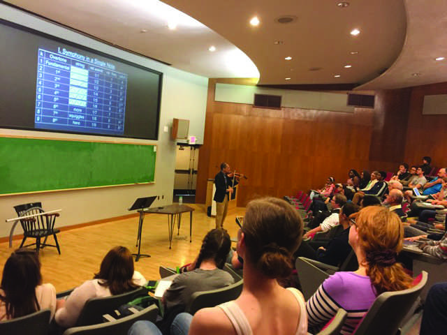 David Kung, professor of mathematics at St. Mary’s College of Maryland, demonstrates mathematical principles with a violin melody in Quigley Auditorium on Monday, September 26, 2016.