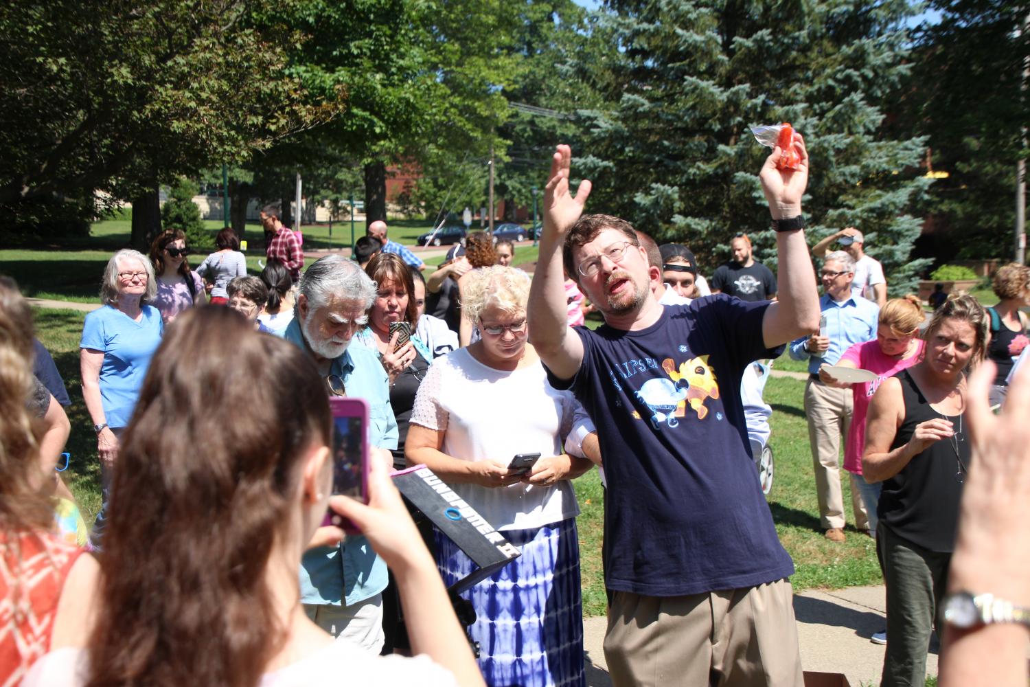 Associate Professor of Physics Jamie Lombardi explains the science of the eclipse to students, faculty and community members outside Newton Observatory on Monday, Aug. 21, 2017.