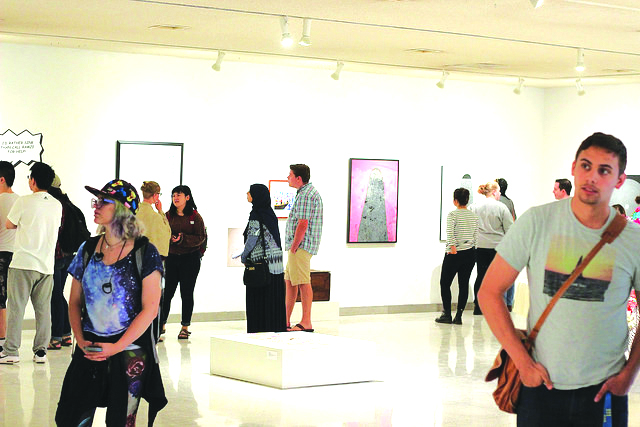 Students and faculty attend the opening reception of ‘Arab Spring/Unfinished Journeys.’