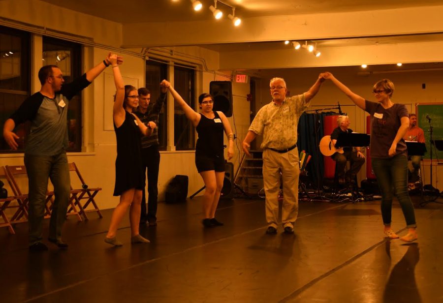 Brian How of Edinboro provides a waltz lesson to Allegheny College students at the contra dance in Montgomery Hall on Oct. 28, 2017.