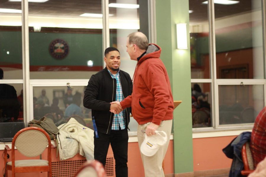 ABC Vice President Allen Baugh, ‘18, and President James Mullen shake hands at the Soul Food Dinner at Schultz Banquet Hall on Sunday, Feb. 11. 