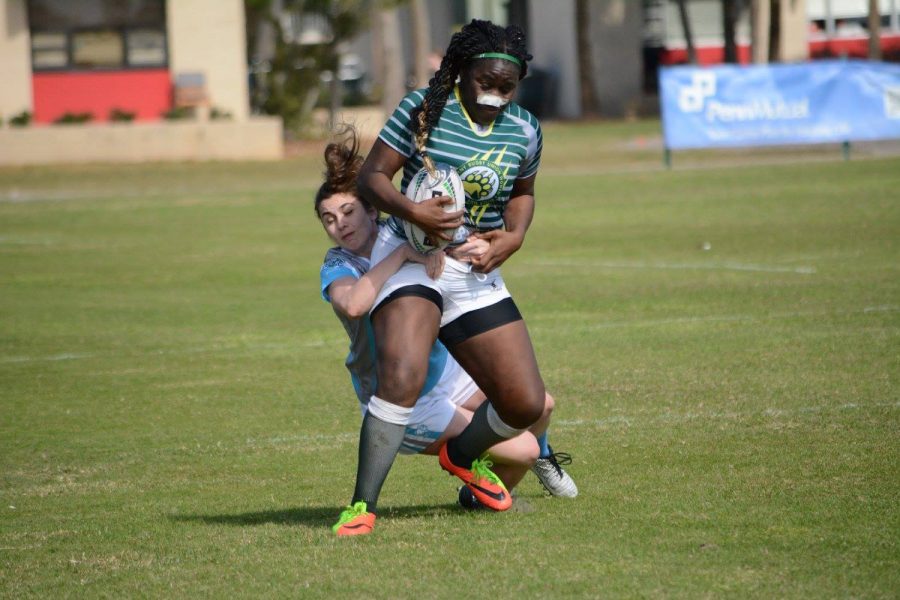 Zafirah Abdulrahoof, ’18, attempts to break a tackle during the National Small College Rugby Organization All-Star Tournament that was held in St. Petersburg, Florida at Eckerd College. 