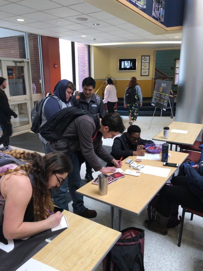 Students sign pledges and write love letters during the Why Not Us Survivor Love Letter event in the Henderson Campus Center lobby Feb. 15, 2018.