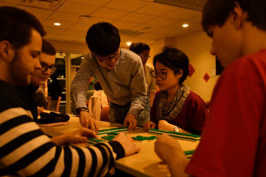 Xingbang Liu, ’20, and Chih-Jung Chen, Chinese language teaching assistant, set up mahjong and teach Alec Tolmachoff, ’20, Thomas Cassidy, ’21, and Malcolm Willig, ’21, how to play.
