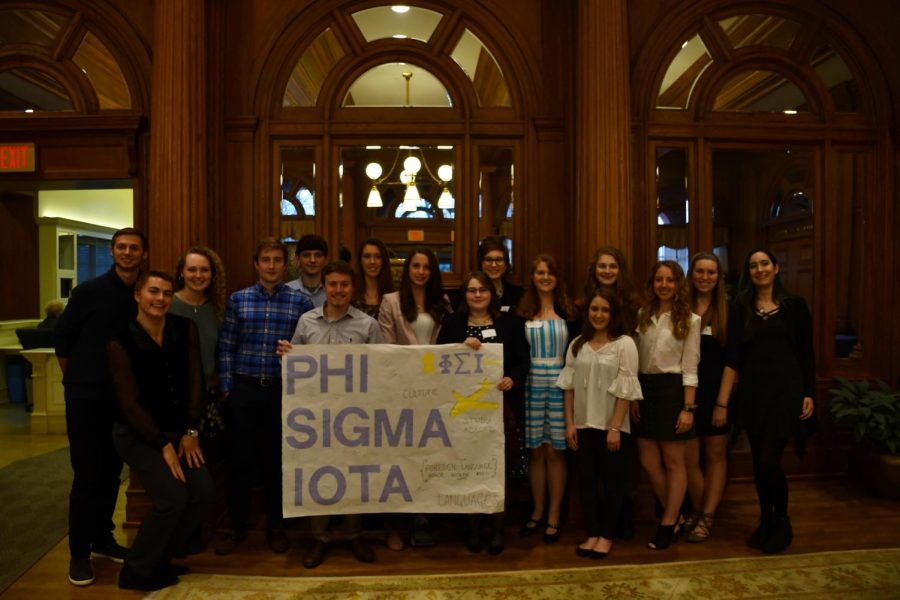 New members of the Phi Sigma Iota foreign language honor society pose with a banner after being inducted on Tuesday, April 10, 2018 in the Tippie Alumni Center. 