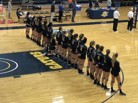 First-year volleyball student-athlete Claire Klima, ‘22, kneels in her team lineup during the national anthem at a home game on September 22, 2018.