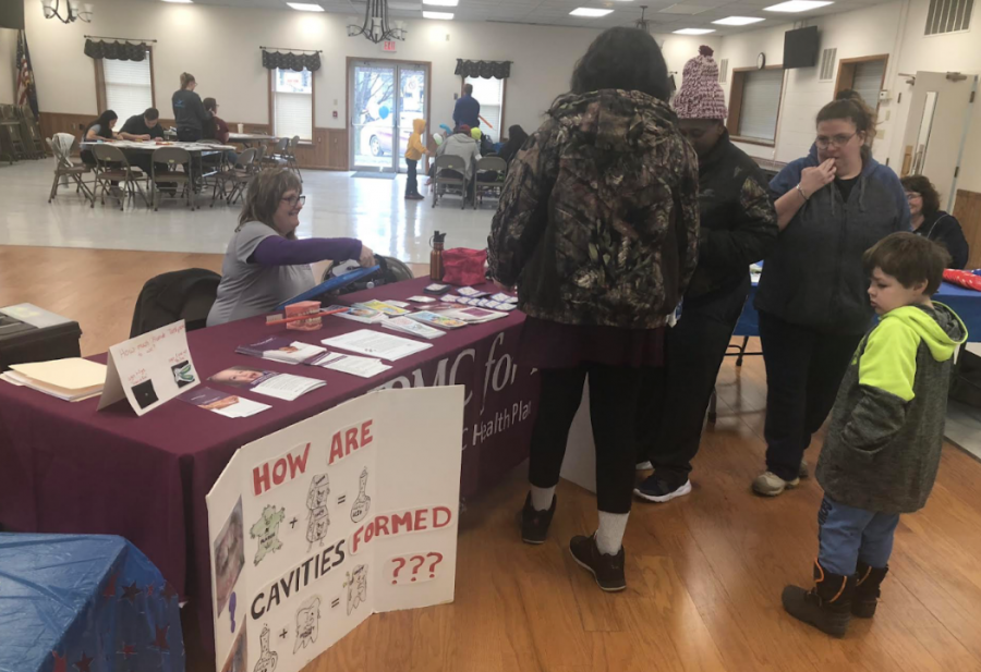Janet Beers, a representative for UPMC for you, provides materials on dental health to attendees of the Children’s Dental Health Fair Saturday, March 2, 2019, at the Lew Davies Community Building. 