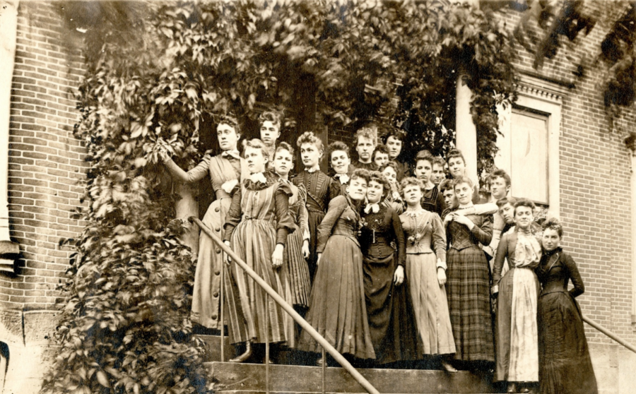 A group of students stand on the steps of Hulings Hall in 1890.