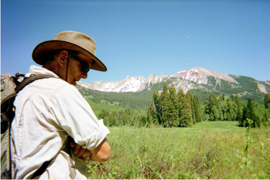 Professor Emeritus of Biology and Environmental Science Scott Wissinger stands in a field during research in summer 2019 in Colorado.