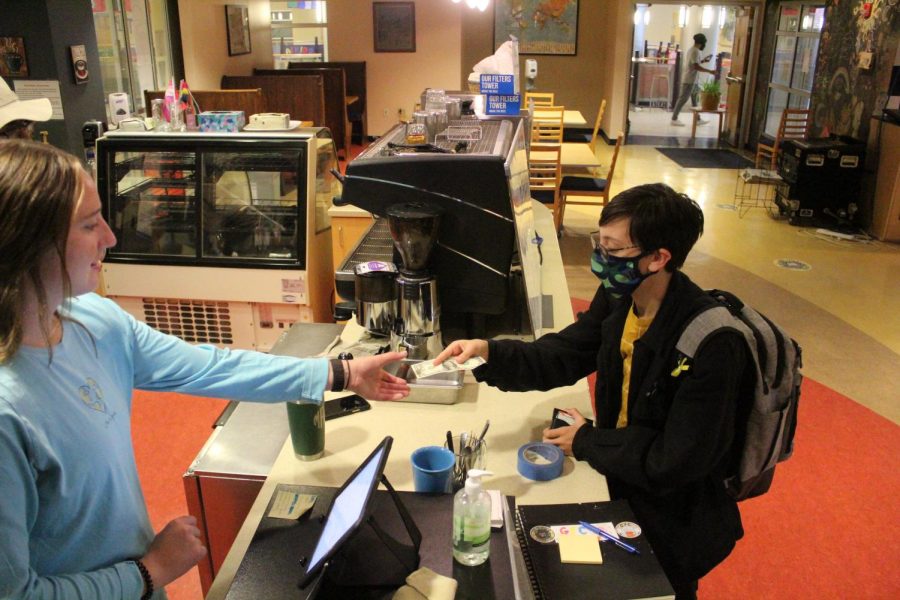 Mary Allen, ’22 takes payment from Charlie Schwartz, ’25, who purchased the first coffee of the year at 8:25am on Monday, Sept. 13. Allen had always wanted to volunteer, but had not followed through until this year. “I just thought it would be cool,” Allen said.