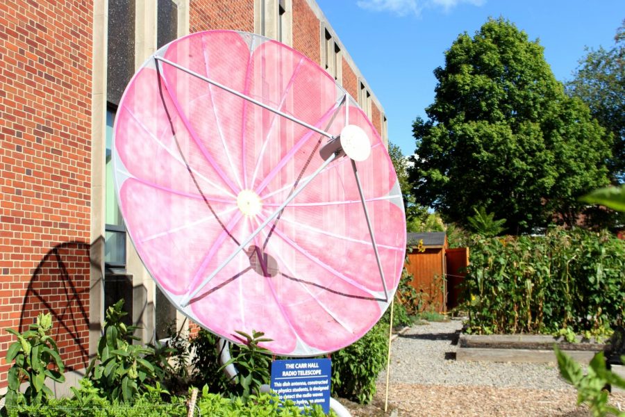 The radio telescope, located in the Carrden next to Carr Hall, was recently painted as a cosmos flower by Ben Ramsey, ’22. Ramsey worked on the radio telescope as part of his summer research with Professor of Physics Dan Willey. 