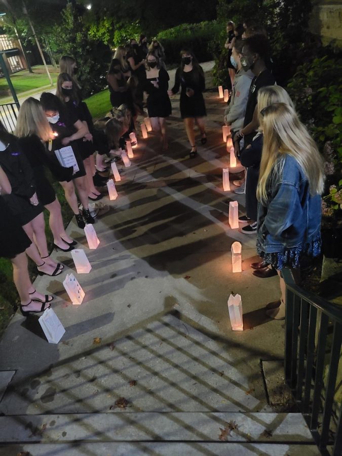 Attendees+honor+victims+of+domestic+violence+with+candles+during+a+vigil+at+the+Ford+Chapel+on+Oct.+16.
