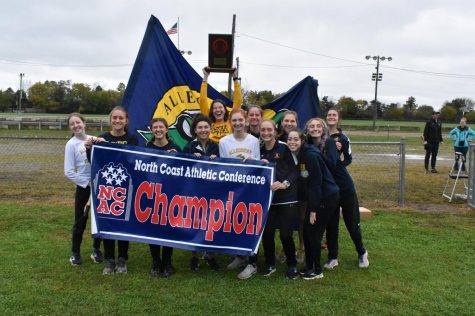 The womens cross country team celebrates their North Coast Athletic Conference title on Oct. 30 in Springfield, Ohio.