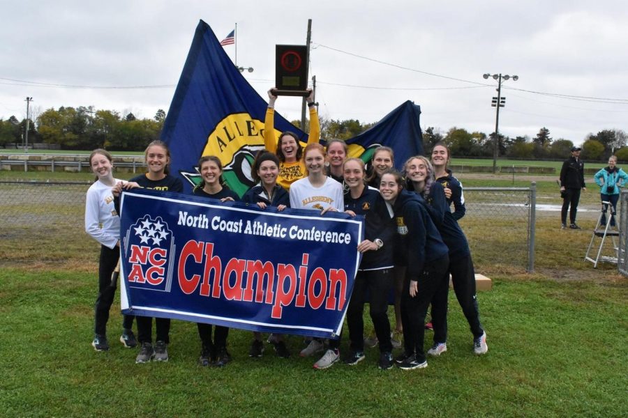 The women's cross country team celebrates their North Coast Athletic Conference title on Oct. 30 in Springfield, Ohio.