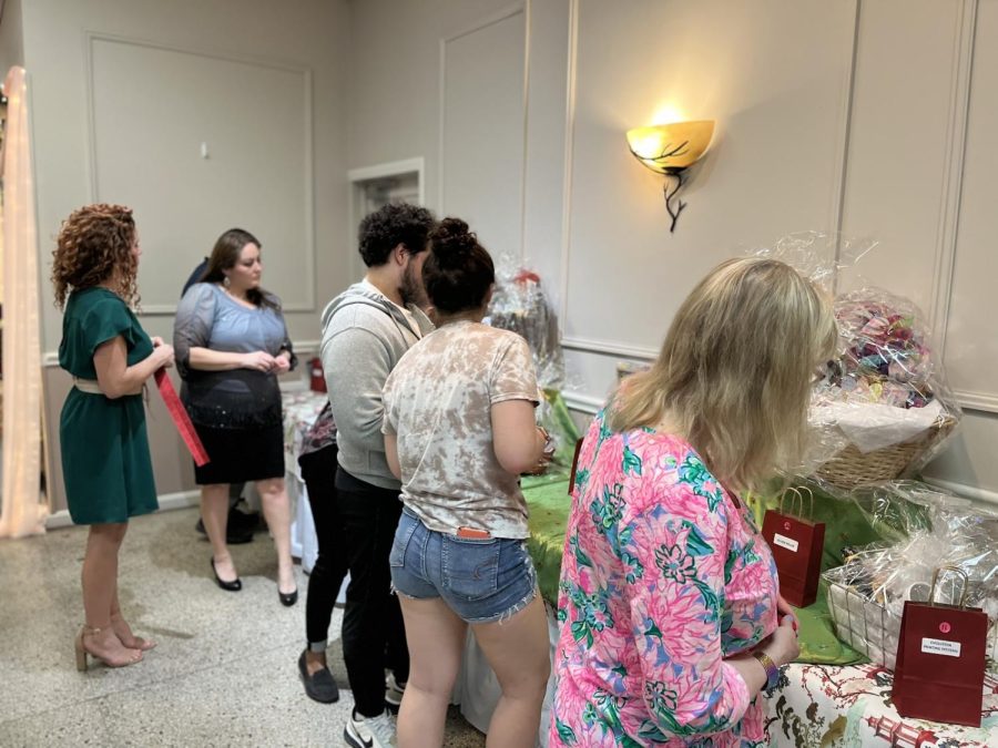 Attendees place auction tickets during a silent auction for baskets put together by local businesses. The event raised money for the Dr. Martin Luther King Jr. Scholarship Fund, which benefits graduating seniors from Meadville Area Senior High School.