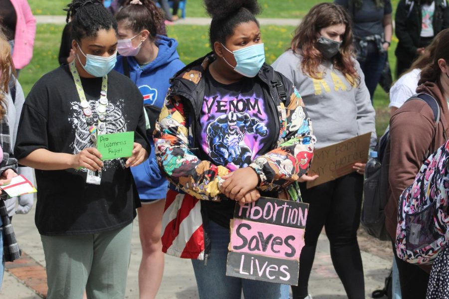 Students carry signs during a May 5 protest in support of abortion rights on the Gator Quad. The protest  was specifically in response to a Monday evening leak of a draft opinion that would overturn the decision in the 1973 Supreme Court case “Roe v. Wade,” which holds that a pregnant woman’s right to choose an abortion is constitutionally protected under the Fourteenth Amendment. 