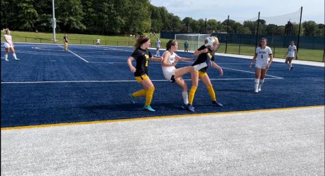 Lilly Noel, ’23, makes a daring play between two Pitt players by kicking the ball over their heads.