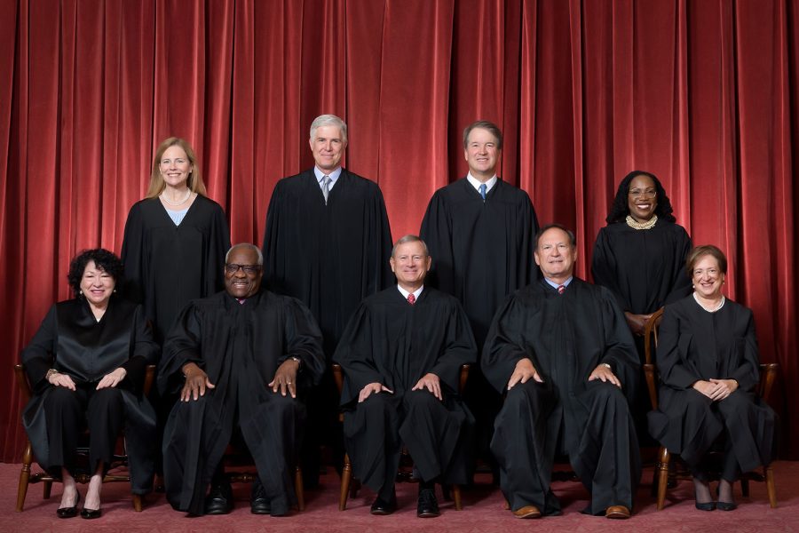Formal group photograph of the Supreme Court as it was been comprised on June 30, 2022 after Justice Ketanji Brown Jackson joined the Court.  The Justices are posed in front of red velvet drapes and arranged by seniority, with five seated and four standing.

Seated from left are Justices Sonia Sotomayor, Clarence Thomas, Chief Justice John G. Roberts, Jr., and Justices Samuel A. Alito and Elena Kagan.  
Standing from left are Justices Amy Coney Barrett, Neil M. Gorsuch, Brett M. Kavanaugh, and Ketanji Brown Jackson.

Credit: Fred Schilling, Collection of the Supreme Court of the United States