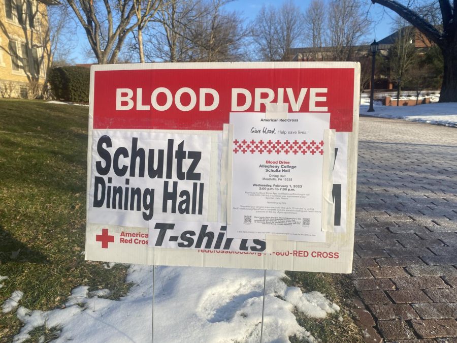 A sign in front of Alden Hall advertising the blood drive.