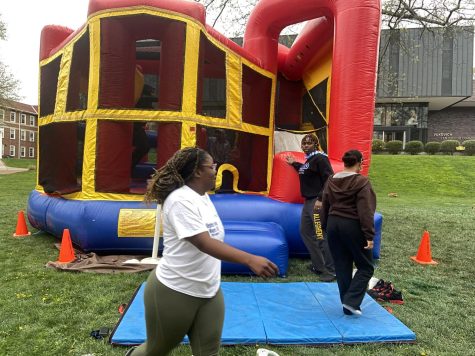 Students enjoy the bouncy house at the “Beach Vibes Cookout” event.