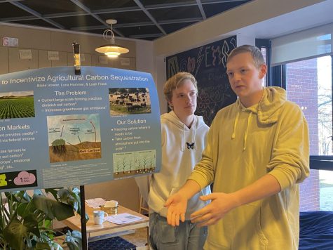 Luna Hammer, ’25, and Blake Vowler, ’25, present their work at a climate teach-in in Grounds for Change on Tuesday, April 4. Their project focused on different ways to incentivize agricultural carbon sequetration.