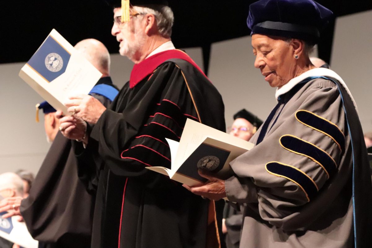 Reverend John Patrick Colatch and Armendia Dixon, Meadville educator and recipient of an honorary Allegheny degree, sing the first verse of the college’s alma mater.