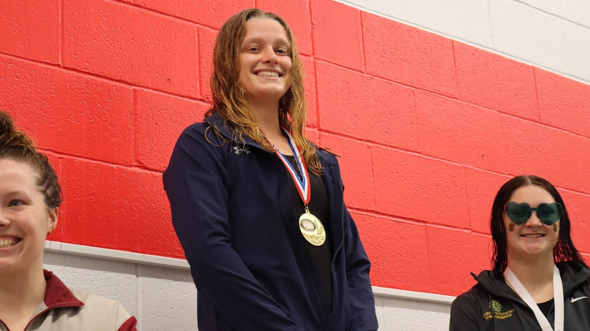 Olivia Kraus, ’24, being crowned the 50 freestyle Champion of the Presidents’ Athletic Conference in 2022.      
