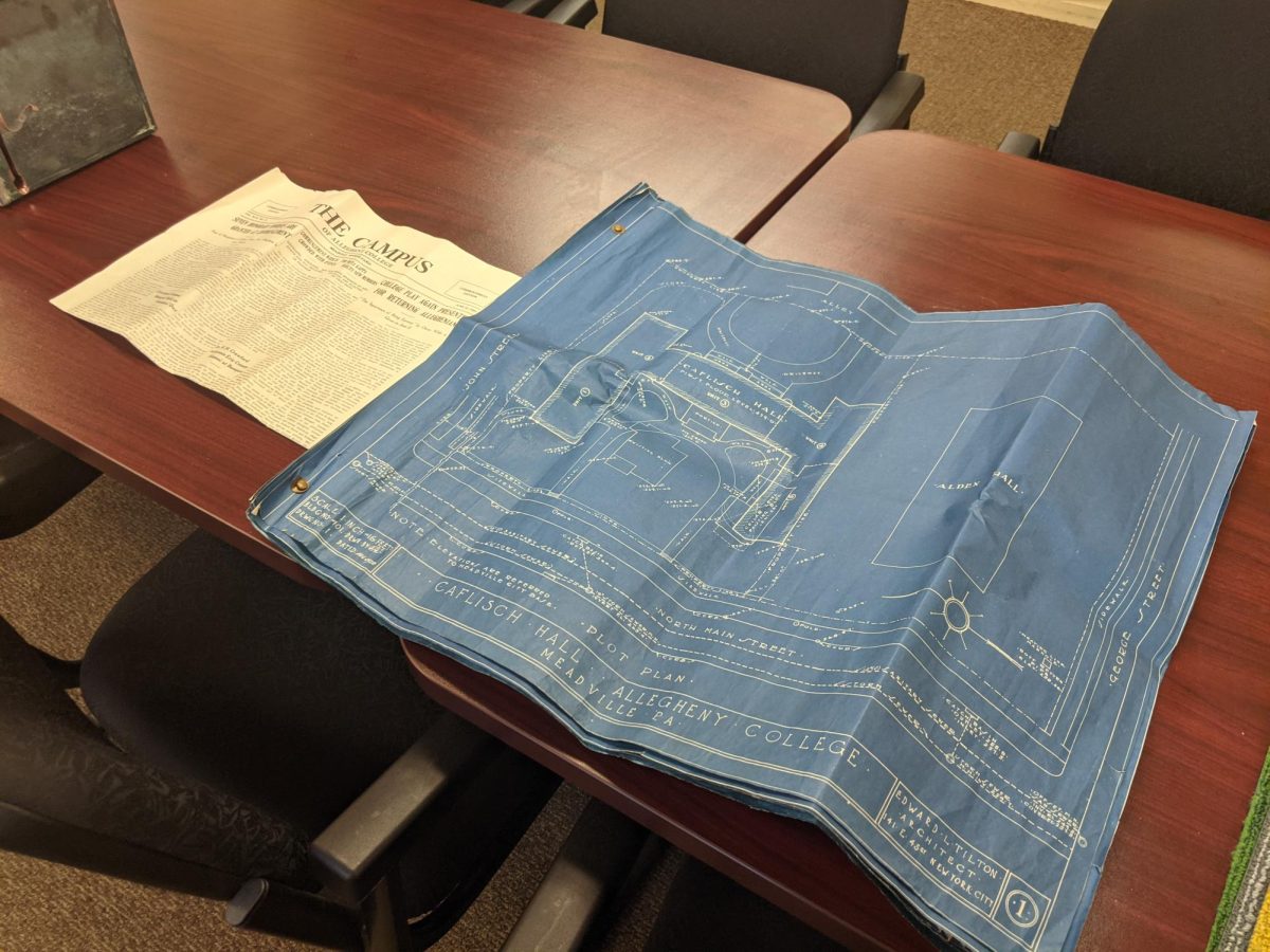 A copy of the original blueprints for Caflisch Hall, next to a copy of The Campus from June 1928.