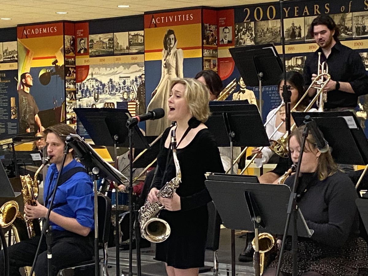 Bella James, ’24, sings a solo during the Jazz Ensemble concert on Sunday, Dec. 3, in the lobby of the Henderson Campus Center.