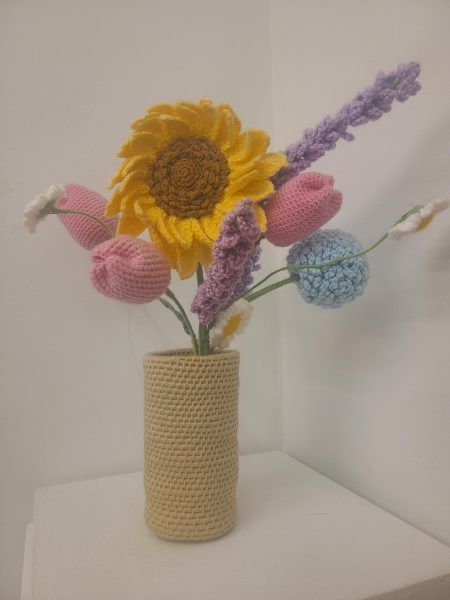 Flowers crocheted by Alyssa Gent, ’27, sit on display during the “Wear and Tear” exhibition on Wednesday, April 10.