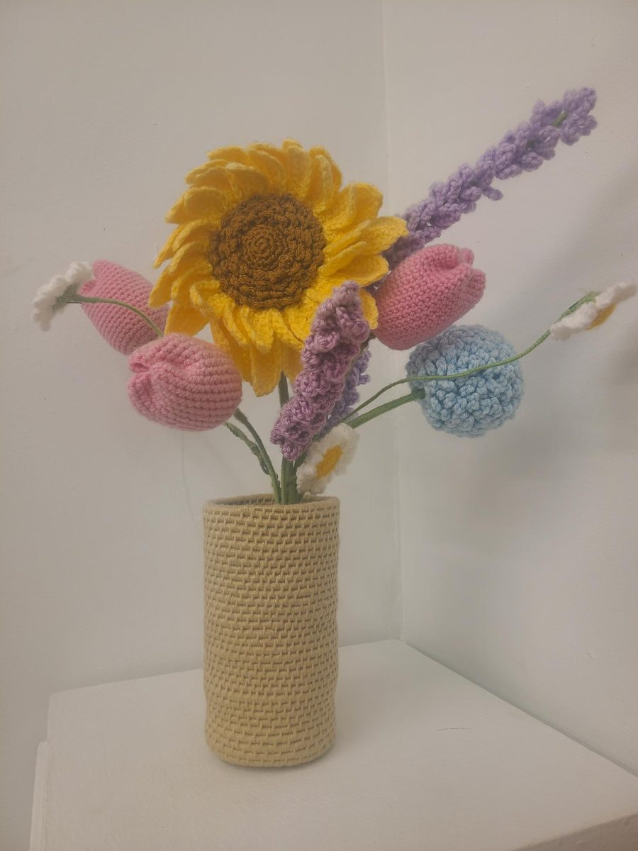 Flowers+crocheted+by+Alyssa+Gent%2C+%E2%80%9927%2C+sit+on+display+during+the+%E2%80%9CWear+and+Tear%E2%80%9D+exhibition+on+Wednesday%2C+April+10.