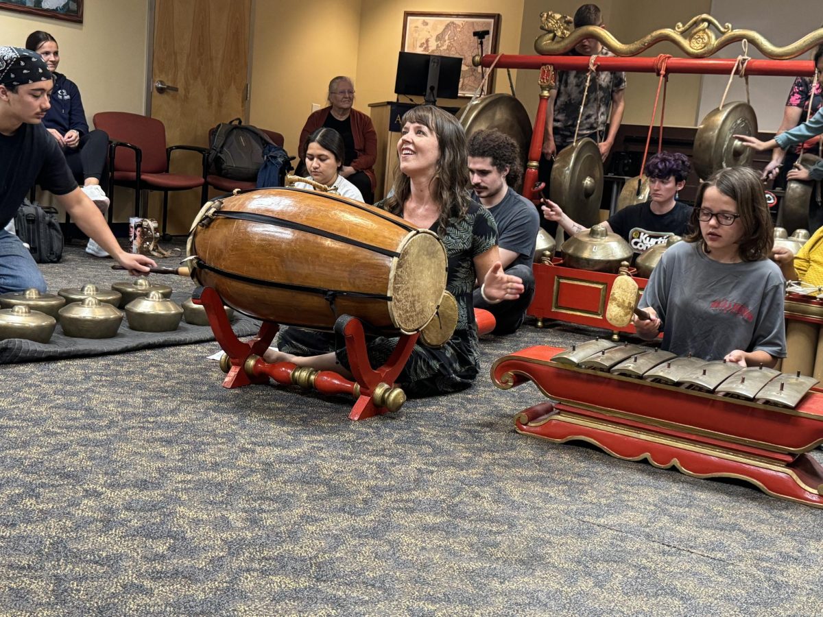 Assistant Professor of Music Hannah Standiford plays the main drum and leads the tempo for the participants.