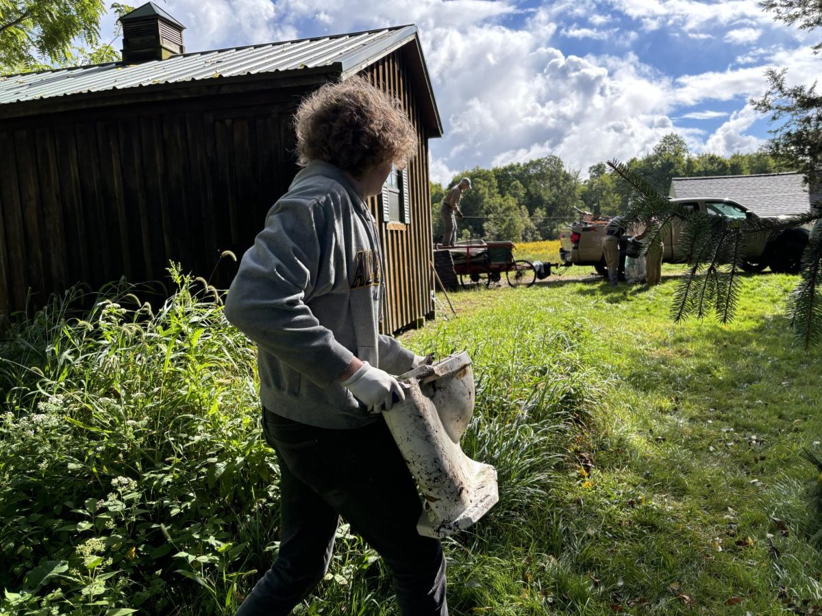 Aidan McGrory, ’26, hauls a toilet that his team found in the forest toward the trash trailer during the annual French Creek Cleanup on Saturday, Sept. 7. This year, in addition to teams working along the creek, students spent time cleaning up the Weyel Estate.