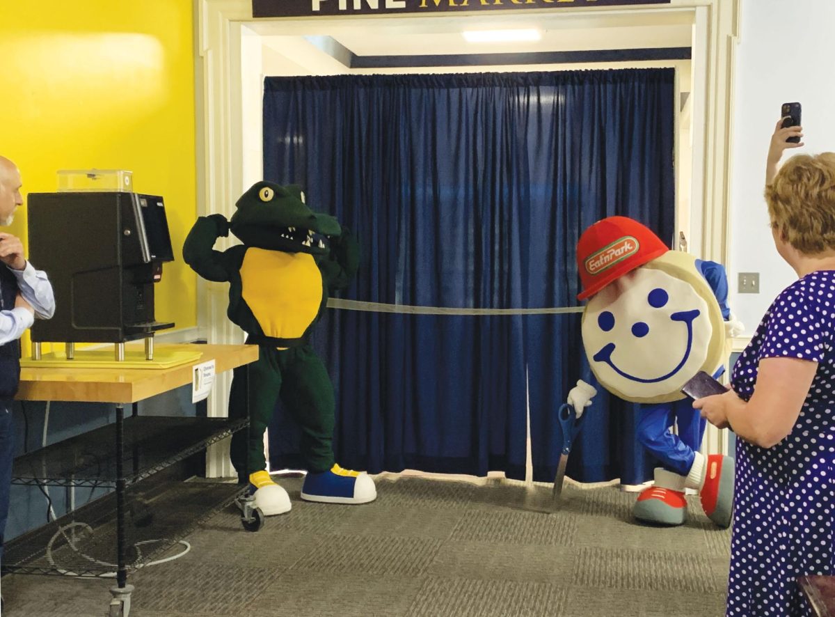 Chompers and Smiley, Eat’n Park’s mascot, smile for the camera at the Pine Market Grand Opening celebration and ribbon-cutting ceremony on Thursday, Nov. 7.